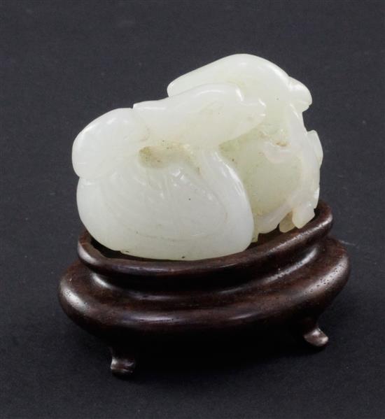 A Chinese white jade carving of two mandarin ducks, 18th / 19th century, 4.8cm., wood stand